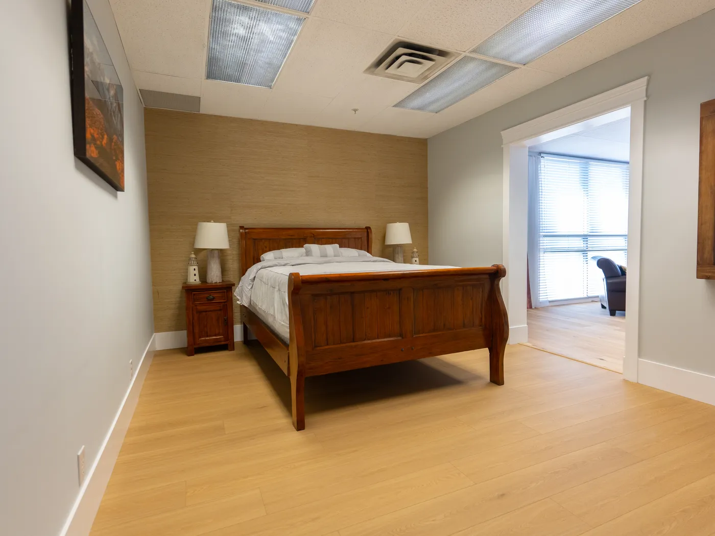 Bedroom display area with light oak flooring restored after water line works