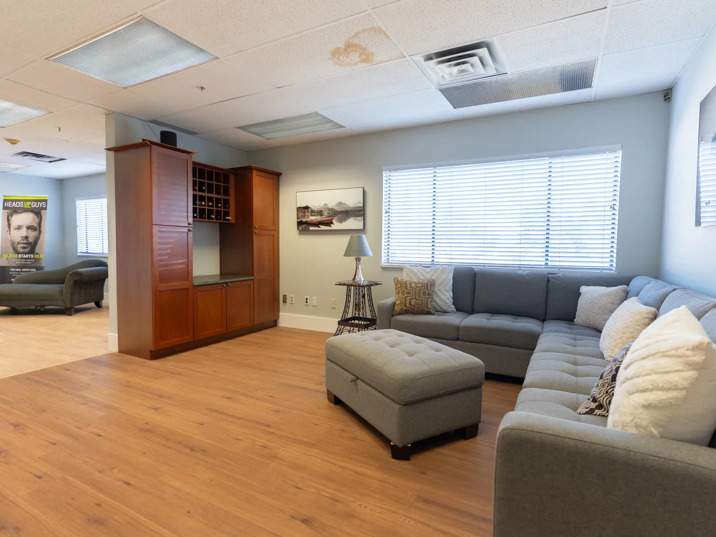 Lounge seating display with restored plank flooring in the King of Floors showroom