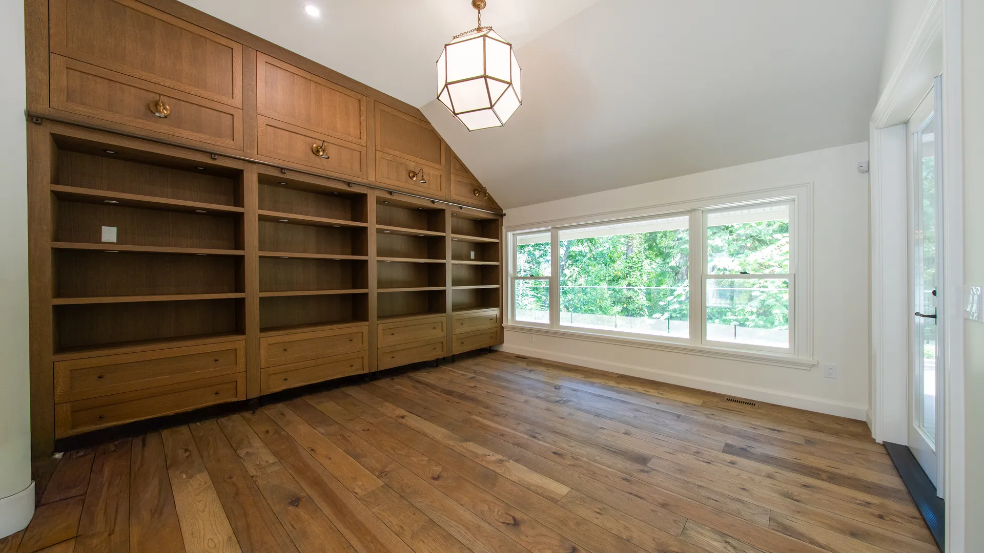 Wall of oak built-in shelving with oak flooring