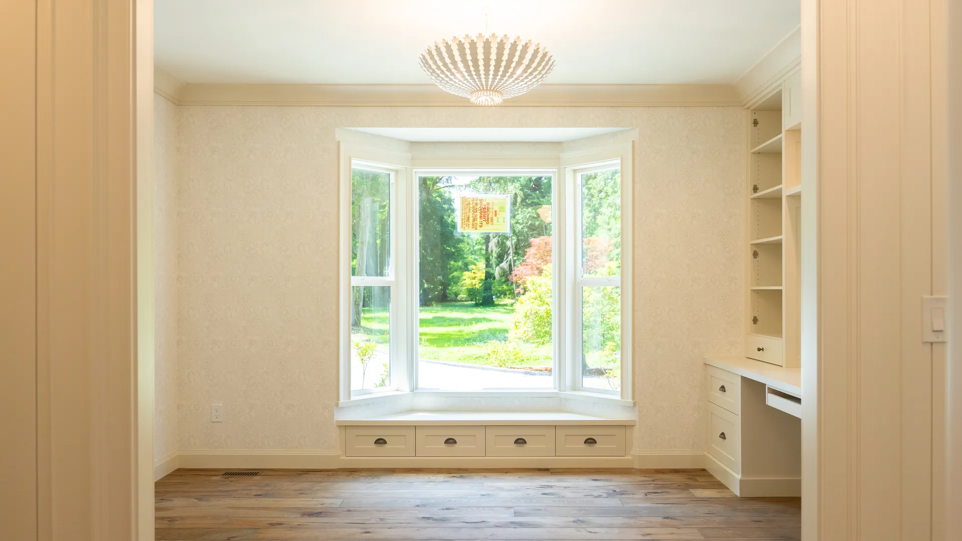 Bay window reading nook with built-in bench and shelving