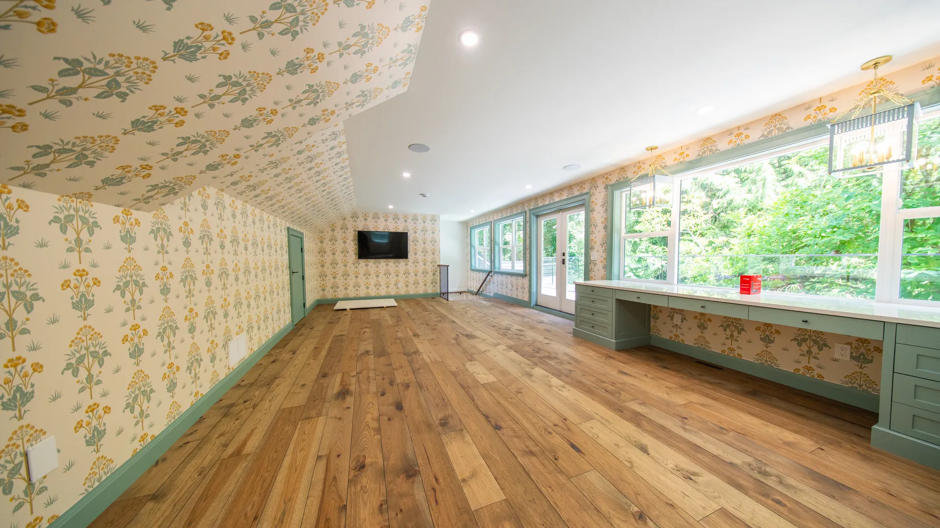 Sunroom addition with floral wallpaper and wall of windows