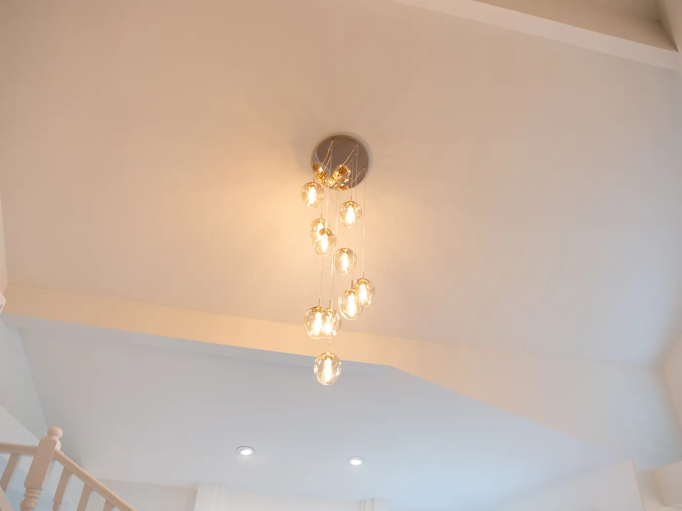 Cascading pendant light in a two-storey stairwell
